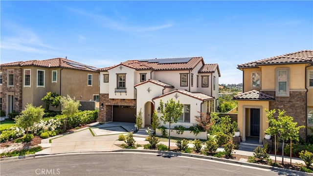 1844 Aliso Canyon Dr, Lake Forest, CA 92610 - mediterranean / spanish house with concrete driveway, a garage, stucco siding, and solar panels