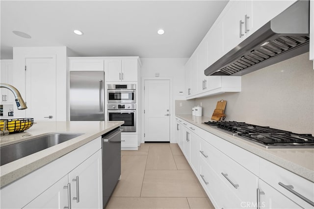 1844 Aliso Canyon Dr, Lake Forest, CA 92610 - kitchen featuring under cabinet range hood, stainless steel appliances, a sink, light tile patterned flooring, and white cabinets