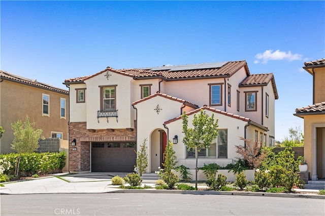 1844 Aliso Canyon Dr, Lake Forest, CA 92610 - mediterranean / spanish-style house with concrete driveway, roof mounted solar panels, an attached garage, a tile roof, and stucco siding