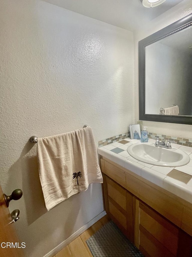 2711 S El Camino Real Unit 7, San Clemente, CA 92672 - bathroom featuring vanity, wood finished floors, and a textured wall