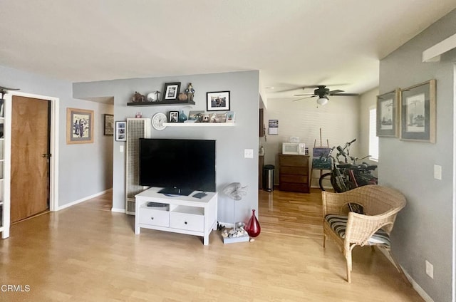 2711 S El Camino Real Unit 7, San Clemente, CA 92672 - living area featuring light wood-type flooring, ceiling fan, and baseboards