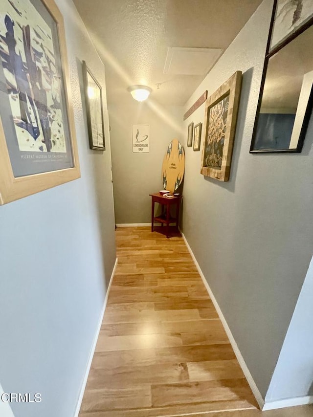 2711 S El Camino Real Unit 7, San Clemente, CA 92672 - corridor with light wood-type flooring, baseboards, and a textured ceiling