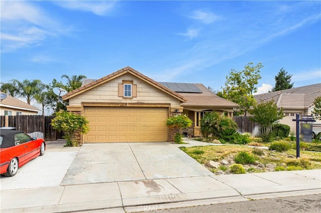 1457 Quiet Ct, Merced, CA 95340 - view of front of property with solar panels, a tile roof, a garage, and driveway