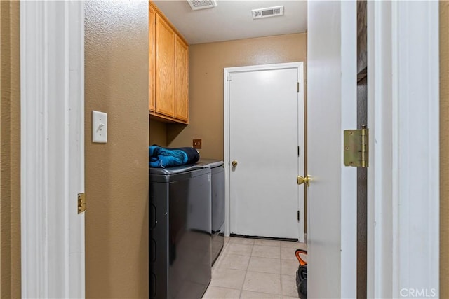 1457 Quiet Ct, Merced, CA 95340 - laundry area with washing machine and dryer, cabinet space, and light tile patterned floors