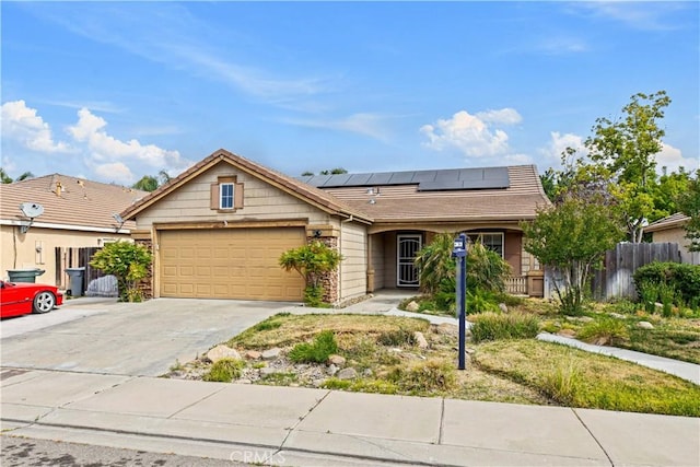 1457 Quiet Ct, Merced, CA 95340 - ranch-style house with an attached garage, solar panels, and driveway
