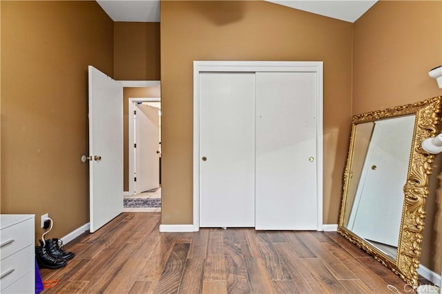 1457 Quiet Ct, Merced, CA 95340 - unfurnished bedroom with dark wood-style flooring, a closet, lofted ceiling, and baseboards
