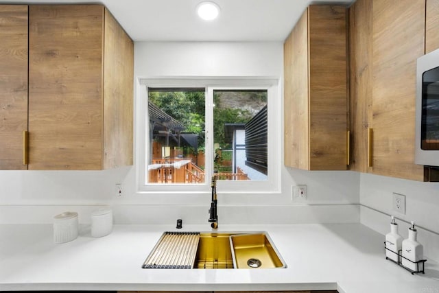 4848 54th St, San Diego, CA 92115 - kitchen featuring a sink, light countertops, and brown cabinets