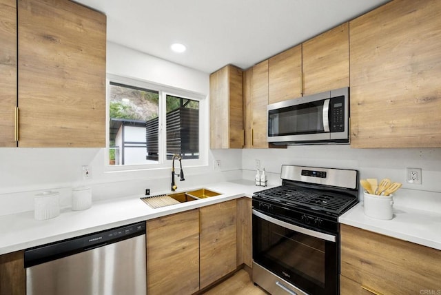 4848 54th St, San Diego, CA 92115 - kitchen with stainless steel appliances, a sink, light countertops, brown cabinetry, and recessed lighting
