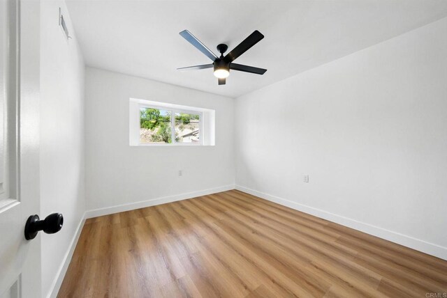 4848 54th St, San Diego, CA 92115 - empty room featuring light wood-type flooring, a ceiling fan, and baseboards