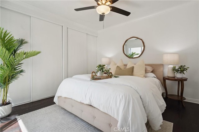 2383 Via Mariposa W Unit C, Laguna Woods, CA 92637 - bedroom with two closets, wood finished floors, and a ceiling fan