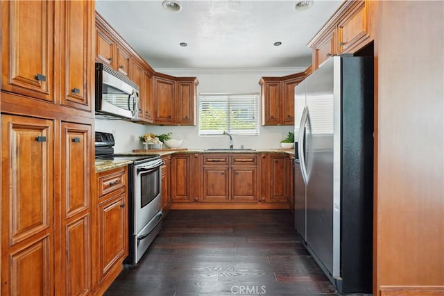 2383 Via Mariposa W Unit C, Laguna Woods, CA 92637 - kitchen with stainless steel appliances, brown cabinets, a sink, light stone countertops, and dark wood finished floors
