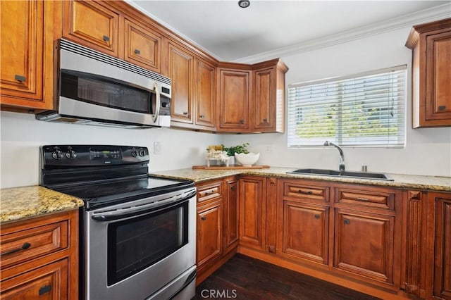 2383 Via Mariposa W Unit C, Laguna Woods, CA 92637 - kitchen featuring stainless steel appliances, a sink, brown cabinetry, ornamental molding, and dark wood finished floors