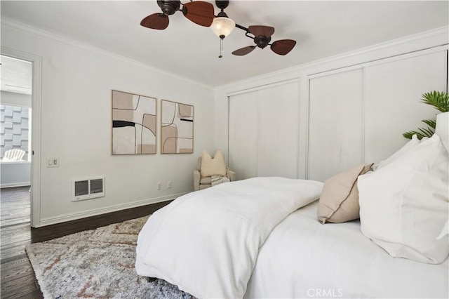 2383 Via Mariposa W Unit C, Laguna Woods, CA 92637 - bedroom featuring ornamental molding, wood finished floors, two closets, baseboards, and a ceiling fan