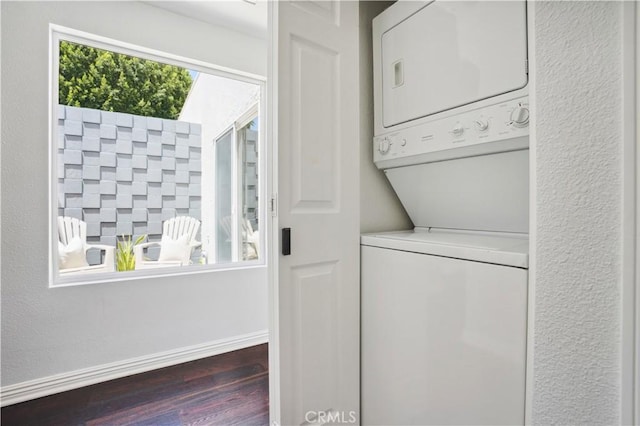 2383 Via Mariposa W Unit C, Laguna Woods, CA 92637 - washroom featuring stacked washer / drying machine, dark wood-style flooring, and baseboards