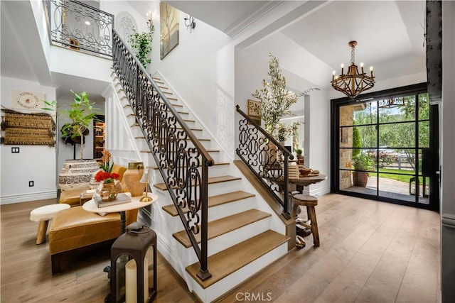 5558 Hoback Glen Rd, Hidden Hills, CA 91302 - staircase with a chandelier, baseboards, wood finished floors, and high vaulted ceiling