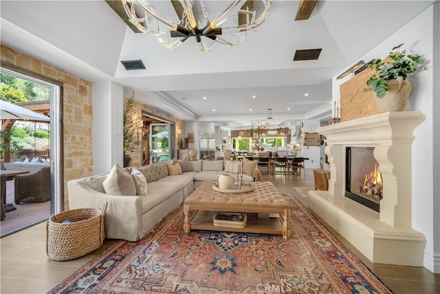 5558 Hoback Glen Rd, Hidden Hills, CA 91302 - living room featuring a chandelier, recessed lighting, high vaulted ceiling, and a lit fireplace