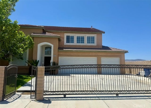 5604 Kingman, Palmdale, CA 93552 - view of front of home featuring stucco siding, a gate, driveway, a mountain view, and a garage