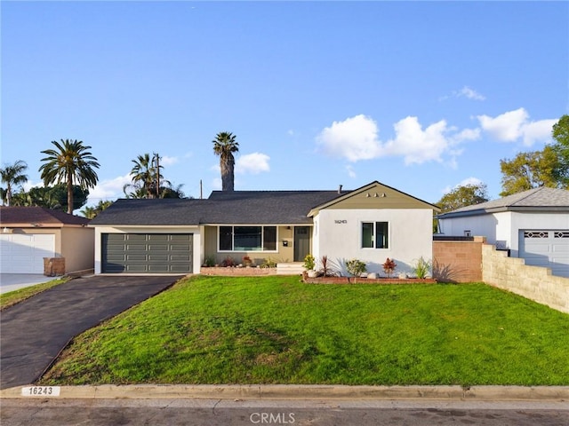 16243 Doublegrove St, La Puente, CA 91744 - single story home with asphalt driveway, a garage, a front lawn, and stucco siding