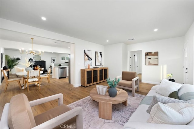 16243 Doublegrove St, La Puente, CA 91744 - living area with light wood-style flooring, recessed lighting, a chandelier, and baseboards