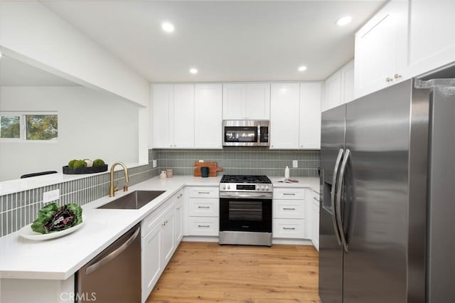 16243 Doublegrove St, La Puente, CA 91744 - kitchen featuring appliances with stainless steel finishes, a sink, a peninsula, decorative backsplash, and recessed lighting