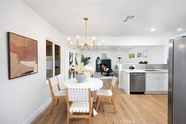16243 Doublegrove St, La Puente, CA 91744 - dining area featuring light wood finished floors, a chandelier, baseboards, and recessed lighting