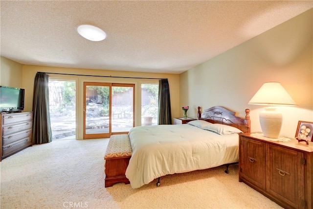 4185 Vanguard Dr, Lompoc, CA 93436 - bedroom featuring access to outside, light colored carpet, multiple windows, and a textured ceiling