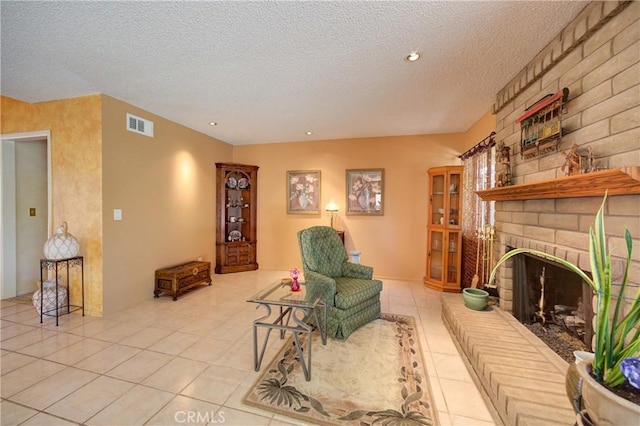 4185 Vanguard Dr, Lompoc, CA 93436 - living room featuring light tile patterned flooring, a textured ceiling, a brick fireplace, and recessed lighting