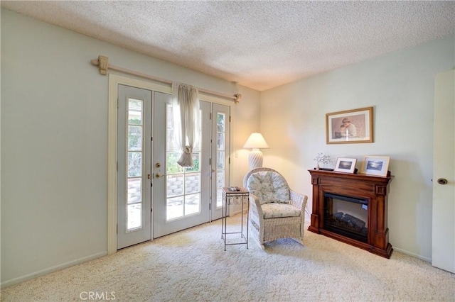 4185 Vanguard Dr, Lompoc, CA 93436 - living area featuring carpet flooring, french doors, a textured ceiling, a glass covered fireplace, and baseboards