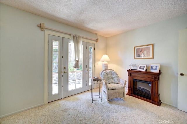 4185 Vanguard Dr, Lompoc, CA 93436 - living area featuring carpet, french doors, a textured ceiling, and a glass covered fireplace