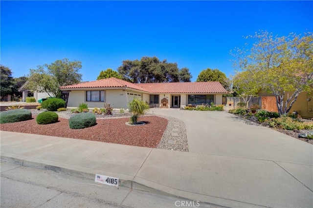 4185 Vanguard Dr, Lompoc, CA 93436 - view of front of house with a tile roof, a garage, driveway, and stucco siding