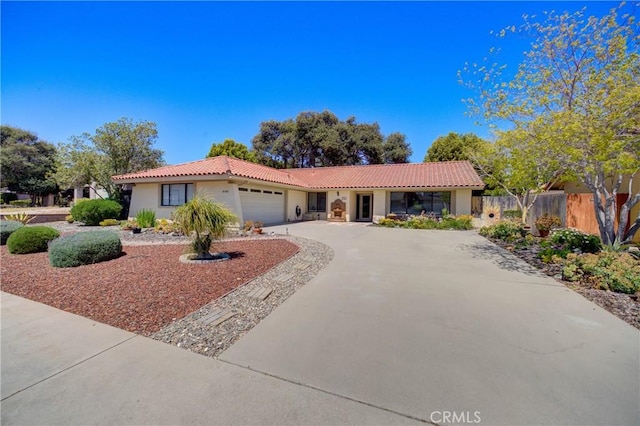 4185 Vanguard Dr, Lompoc, CA 93436 - view of front facade with a tiled roof, a garage, stucco siding, and concrete driveway