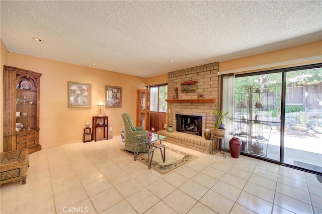 4185 Vanguard Dr, Lompoc, CA 93436 - living area with a textured ceiling, tile patterned floors, a brick fireplace, and recessed lighting