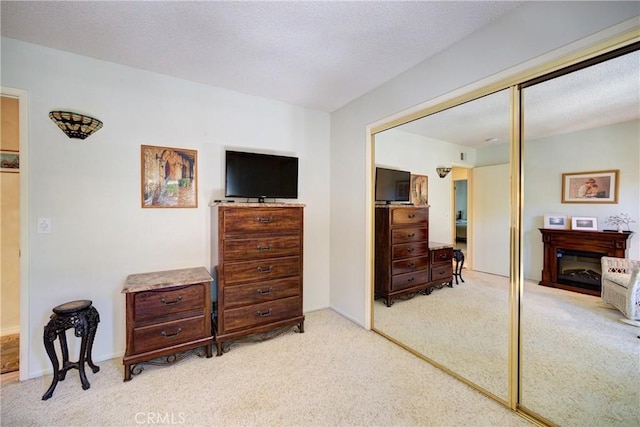 4185 Vanguard Dr, Lompoc, CA 93436 - bedroom with a closet, light carpet, and a glass covered fireplace