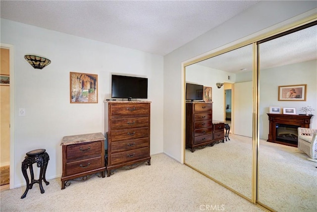 4185 Vanguard Dr, Lompoc, CA 93436 - bedroom featuring a closet, light colored carpet, and a glass covered fireplace