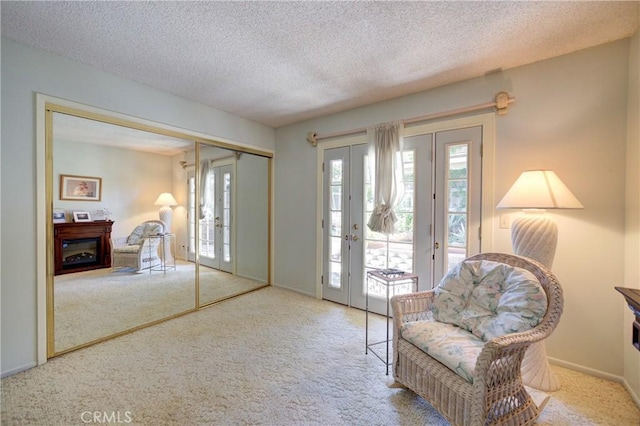4185 Vanguard Dr, Lompoc, CA 93436 - foyer with french doors, carpet flooring, healthy amount of natural light, a textured ceiling, and a fireplace