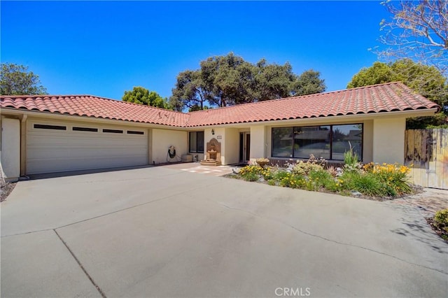 4185 Vanguard Dr, Lompoc, CA 93436 - mediterranean / spanish-style home with stucco siding, an attached garage, a tile roof, and concrete driveway