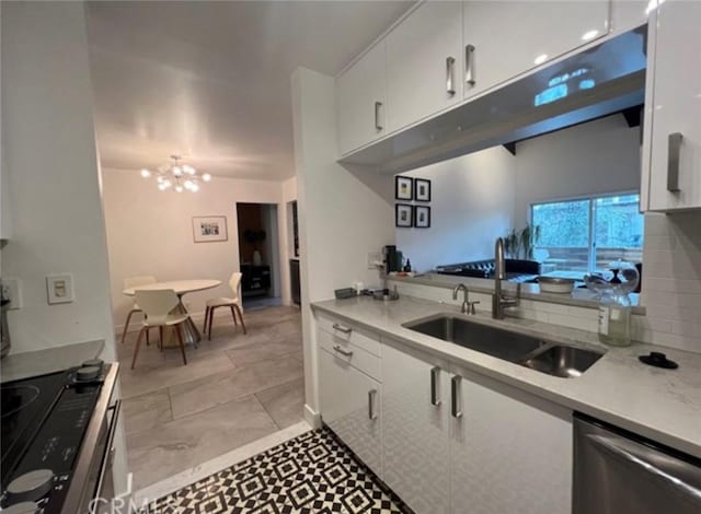 5460 White Oak Ave Unit A305, Encino, CA 91316 - kitchen with a sink, dishwasher, white cabinets, light countertops, and a chandelier