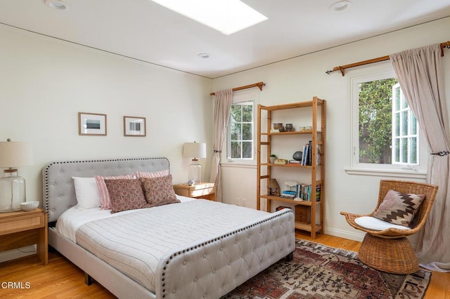 394 S Bonnie Ave, Pasadena, CA 91106 - bedroom with multiple windows, wood finished floors, and baseboards