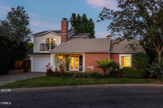394 S Bonnie Ave, Pasadena, CA 91106 - traditional-style house featuring a balcony, french doors, a chimney, a garage, and driveway