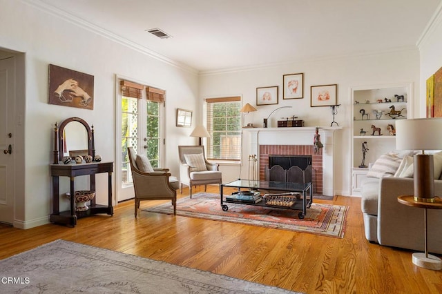 394 S Bonnie Ave, Pasadena, CA 91106 - living room featuring crown molding, wood finished floors, a brick fireplace, and built in features