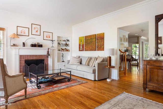 394 S Bonnie Ave, Pasadena, CA 91106 - living room featuring ornamental molding, wood finished floors, a brick fireplace, and built in features