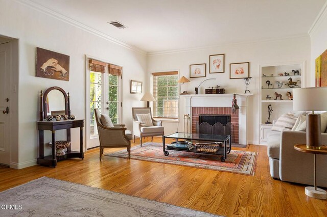 394 S Bonnie Ave, Pasadena, CA 91106 - living area with crown molding, wood finished floors, a fireplace, and built in features