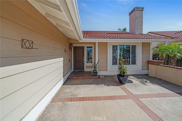 27175 Via Debra, Menifee, CA 92586 - property entrance with a chimney, a tile roof, and a patio