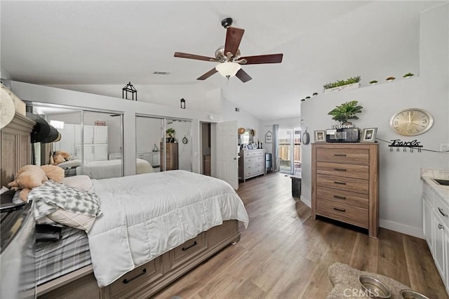 27175 Via Debra, Menifee, CA 92586 - bedroom with vaulted ceiling, multiple closets, light wood-style flooring, baseboards, and ceiling fan
