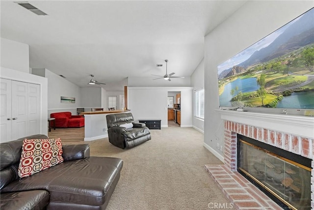 27175 Via Debra, Menifee, CA 92586 - living room with lofted ceiling, carpet flooring, ceiling fan, a brick fireplace, and baseboards