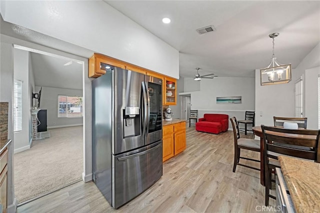 27175 Via Debra, Menifee, CA 92586 - kitchen with stainless steel refrigerator with ice dispenser, light wood-style flooring, a fireplace, a chandelier, and a ceiling fan