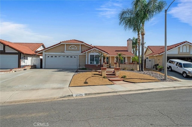 27175 Via Debra, Menifee, CA 92586 - view of front of house with a tiled roof, an attached garage, concrete driveway, and a chimney