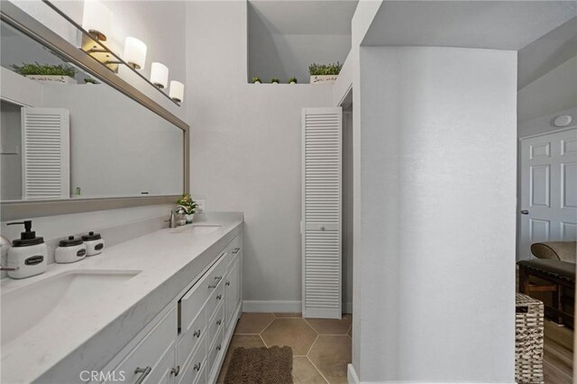 27175 Via Debra, Menifee, CA 92586 - bathroom featuring a closet, double vanity, tile patterned flooring, and baseboards