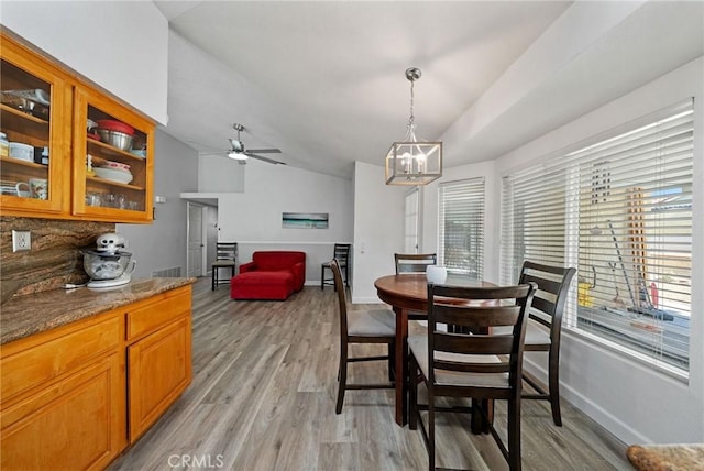 27175 Via Debra, Menifee, CA 92586 - dining room with light wood-style flooring, baseboards, a chandelier, a ceiling fan, and vaulted ceiling