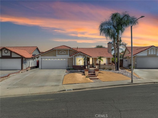 27175 Via Debra, Menifee, CA 92586 - mediterranean / spanish-style house featuring a tile roof, driveway, a garage, and a chimney